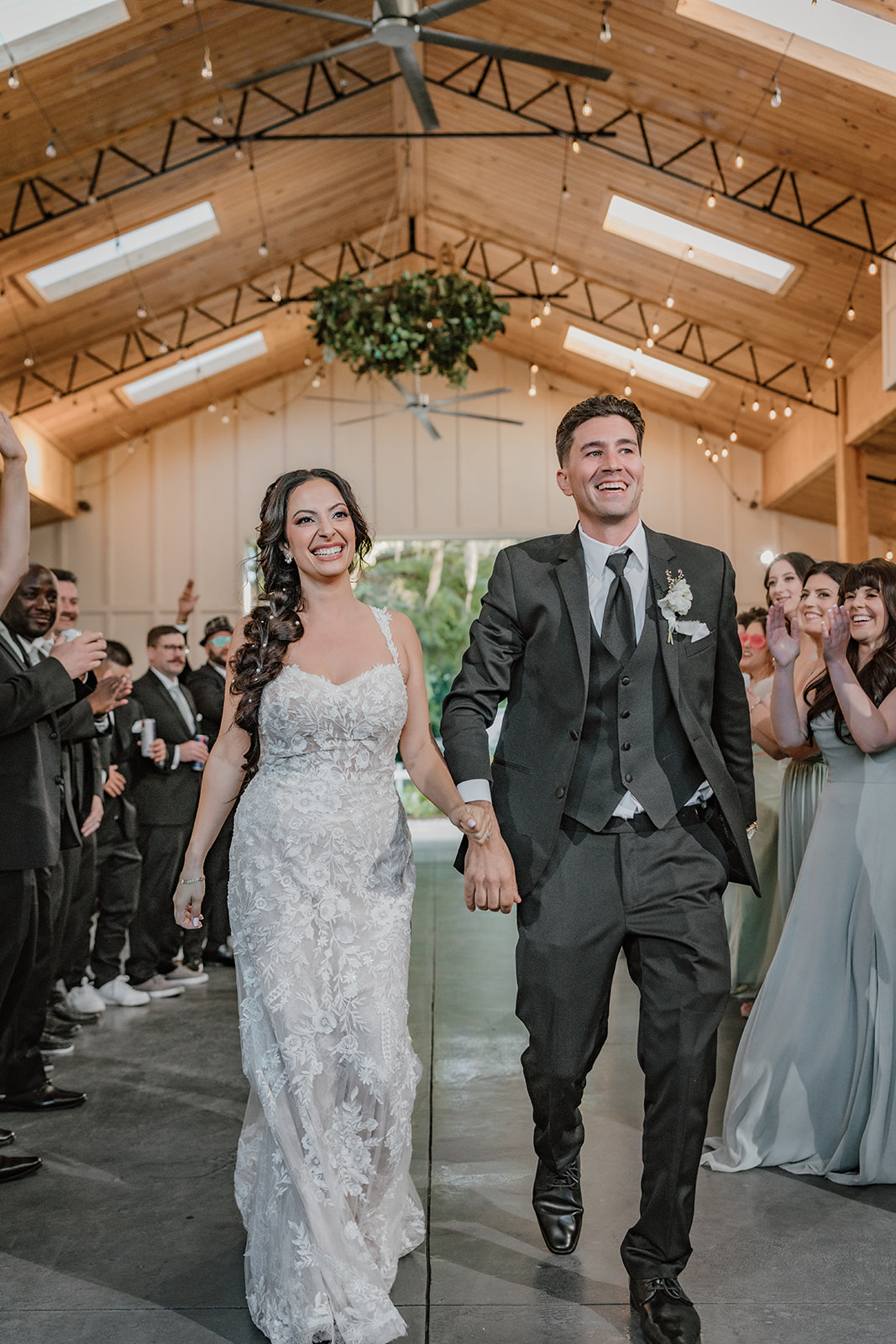 man and woman walking into a wedding recpetion holding hands