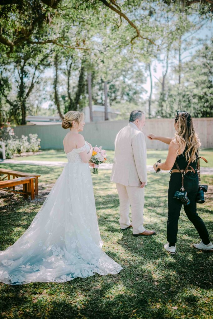 wedding photographer posing bride and father outdoors