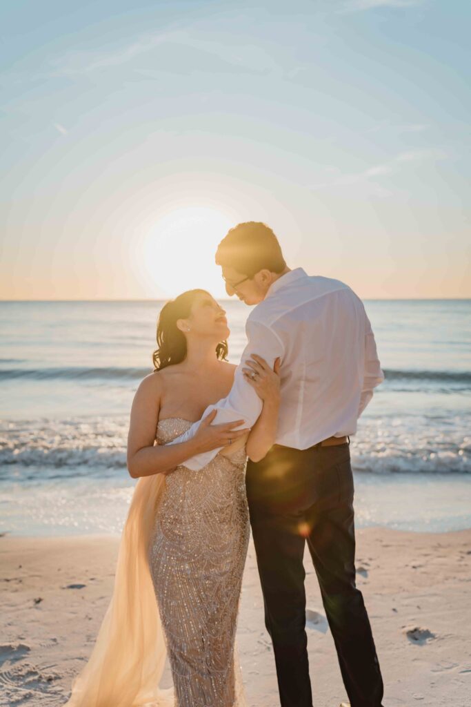 sun setting at beach with man and woman looking at each other