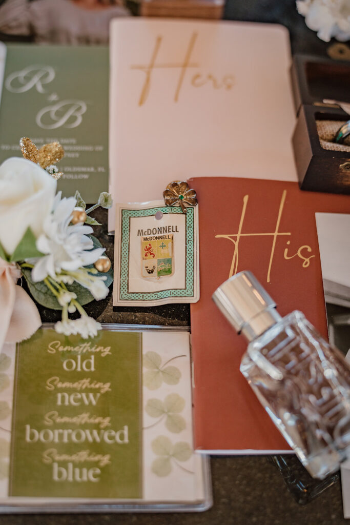 flatlay detail shot of vow books, perfume, and flowers