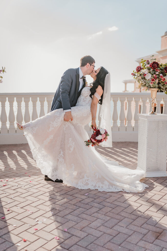 bride and groom kissing and dipping after wedding ceremony