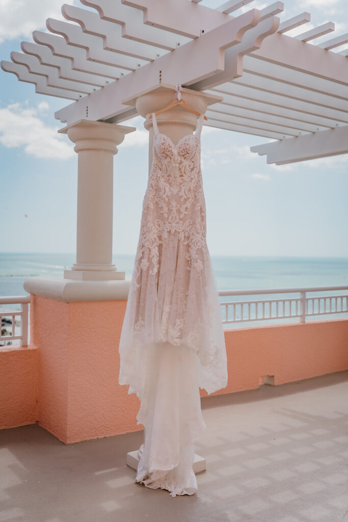 wedding dress hanging from a pergola