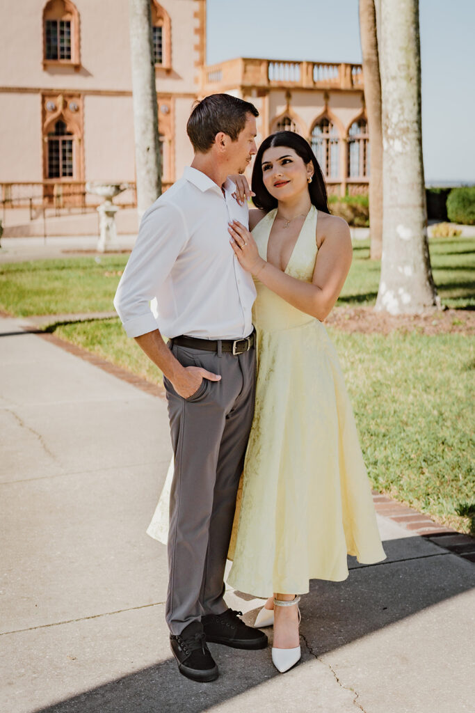 man and woman looking at each other with her hand on his chest