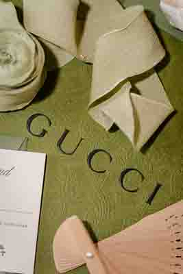 gucci flat lay box with olive green ribbon