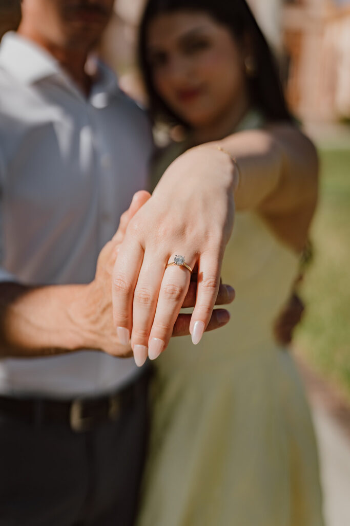 detail shot of engagement ring on woman's hand