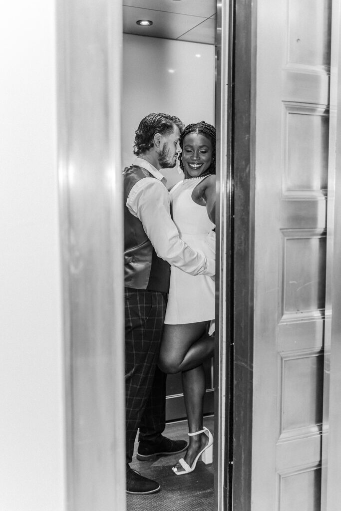 black and white photo of a couple in an elevator