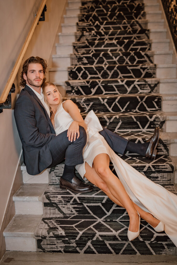 man and woman sitting next to each other sitting on the steps