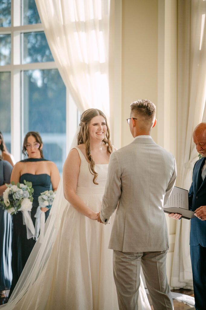 lake mary event center wedding ceremony of man and woman holding hands looking at each other